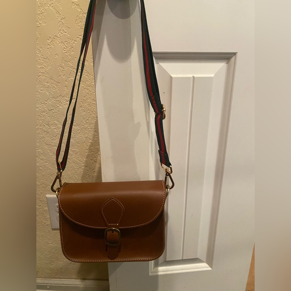 Brown cross body with green and red strap